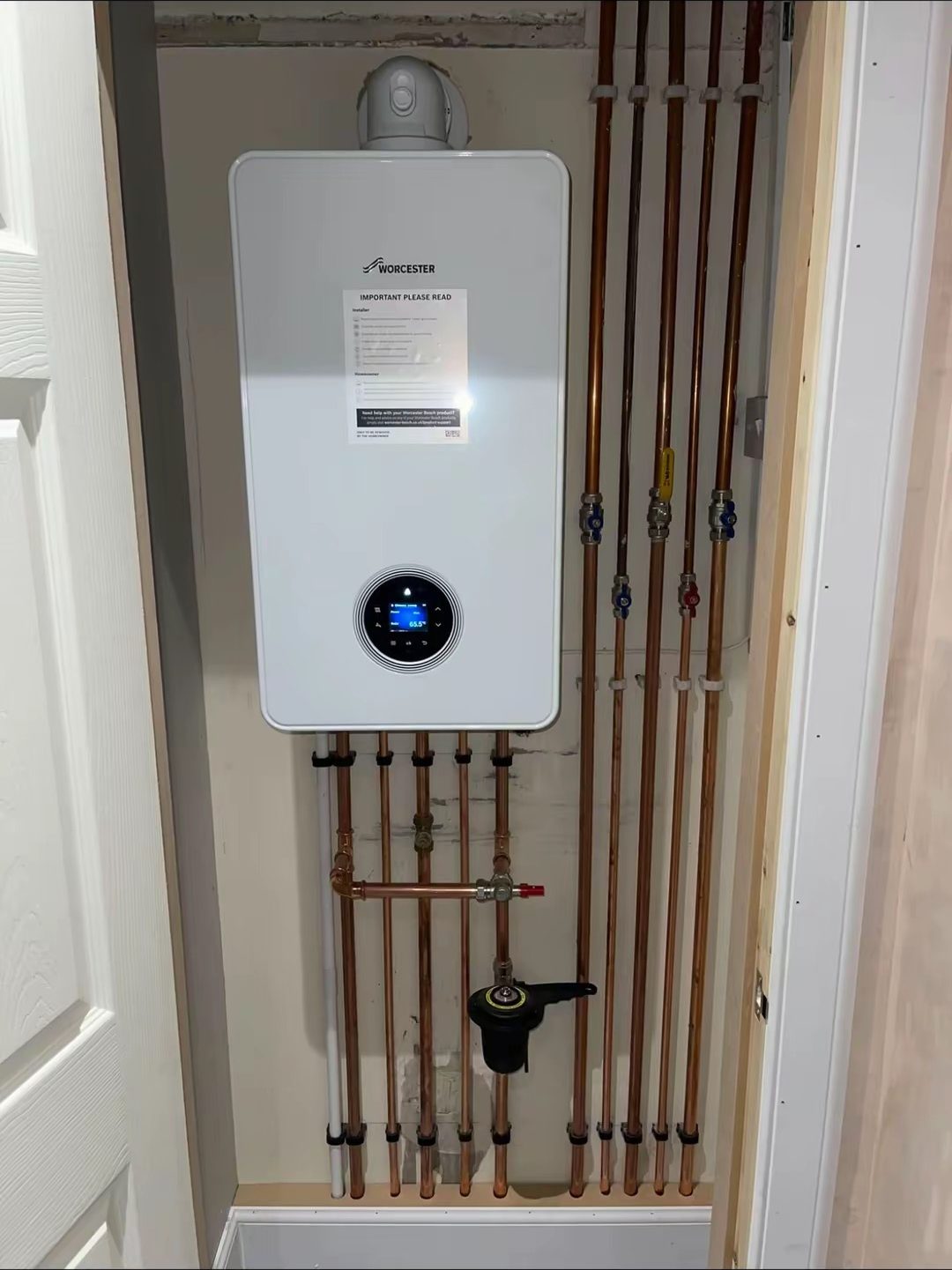 Wall-mounted combi boiler installation with neat copper pipework in Edinburgh