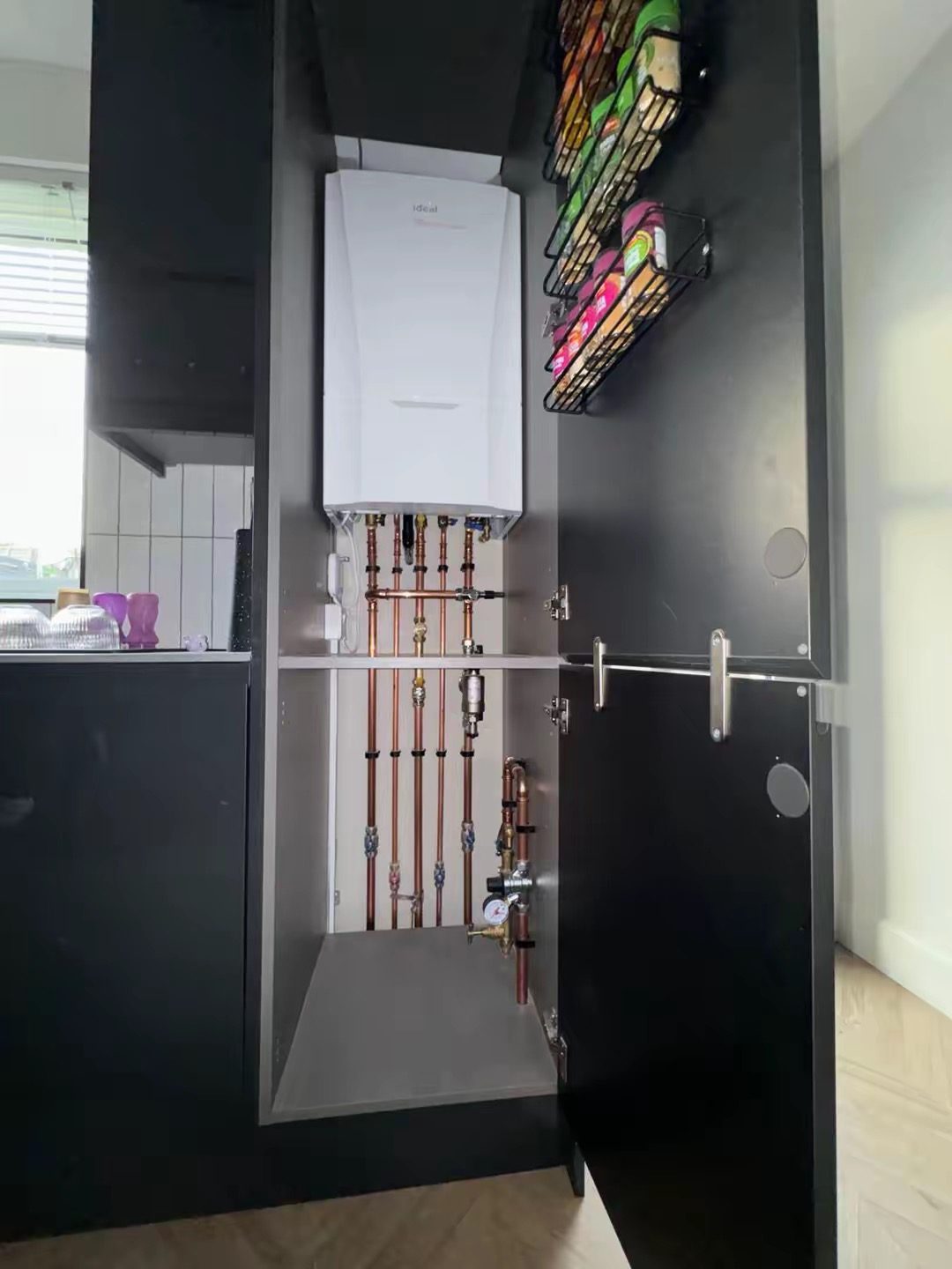 Ideal boiler fitted inside a kitchen cabinet with concealed pipework in Dalkeith